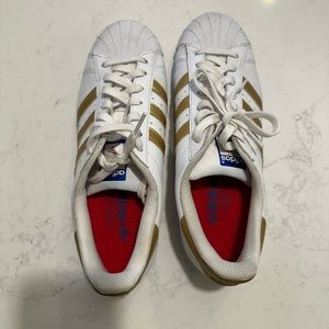 Adidas shell-toe gold striped sneakers